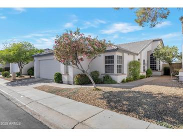 Charming home featuring a well-manicured yard and inviting curb appeal with decorative trees at 510 W Marconi Ave, Phoenix, AZ 85023