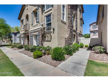 Lovely townhome with stone accents, shutters, and manicured landscaping at 5729 S 21St Ter, Phoenix, AZ 85040