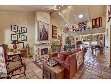 Comfortable living room features a fireplace, tile flooring, and access to the dining area at 5738 N Scottsdale Rd, Scottsdale, AZ 85253