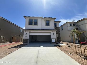 Two-story home with a two car garage, neutral paint, and a stone facade at 7433 W Rovey Ave, Glendale, AZ 85303
