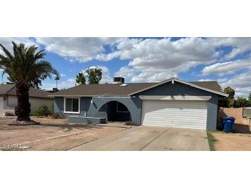 Charming single-story home with a well-maintained front yard and a two-car garage at 836 W Laguna Azul Ave, Mesa, AZ 85210