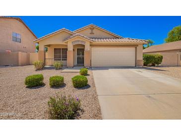 Charming single-story home featuring a tile roof, desert landscaping and a spacious two car garage at 1071 E Chelsea Dr, San Tan Valley, AZ 85140