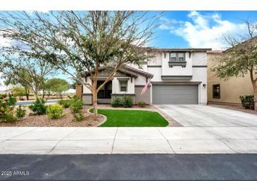 Charming two-story home with a well-maintained lawn, desert landscaping, and a two car garage at 1140 E Vermont Dr, Gilbert, AZ 85295