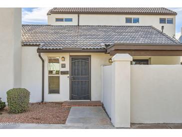 Inviting front entrance showcasing a secure gate, address number, and well-maintained landscaping at 1147 E Belmont Ave, Phoenix, AZ 85020