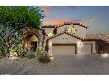 Stunning two-story home featuring a three-car garage, desert landscaping, and beautiful sunset colors at 15215 S 20Th Pl, Phoenix, AZ 85048