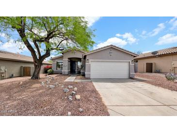 Charming single-story home featuring a two car garage, desert landscaping, and a welcoming entryway at 18371 W Sunrise Dr, Goodyear, AZ 85338