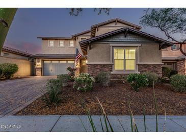 Charming two-story home featuring a neatly landscaped front yard and a two-car garage at 2557 N Springfield St, Buckeye, AZ 85396