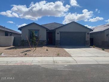 Charming single-story home featuring a gray color scheme, low-maintenance landscaping, and a spacious two-car garage at 31619 N Shady Pasture Ln, San Tan Valley, AZ 85143