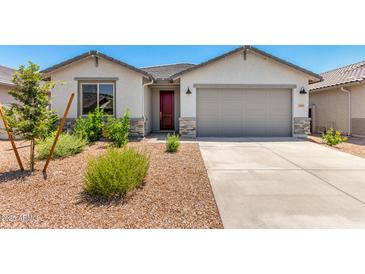 Charming home with a well-manicured yard, a neutral facade, and an attached garage, complete with a dark door at 31619 N Shady Pasture Ln, San Tan Valley, AZ 85143
