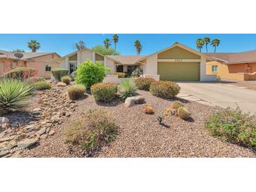 Charming single-story home featuring desert landscaping, a two-car garage, and a well-maintained front yard at 4815 E Everett Dr, Scottsdale, AZ 85254
