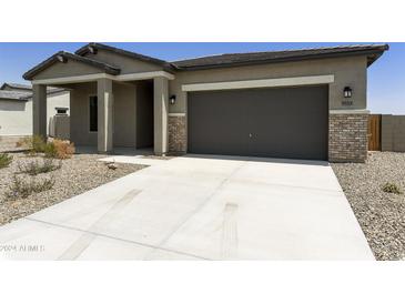 Charming single-story home with a two-car garage and low-maintenance desert landscaping at 5533 N 193Rd Ave, Litchfield Park, AZ 85340