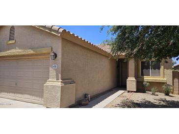 Charming single-Gathering home with desert landscaping and a tan-colored exterior and a two car garage at 6722 W Shannon St, Chandler, AZ 85226