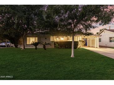 Inviting front exterior featuring well-maintained landscaping, mature trees, and a cozy, suburban aesthetic at 728 E State Ave, Phoenix, AZ 85020