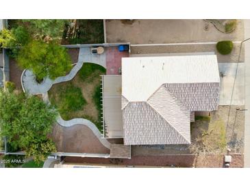An aerial view showcases the home's spacious backyard, landscaping, and covered patio at 13261 W Gelding W Cir, Surprise, AZ 85379