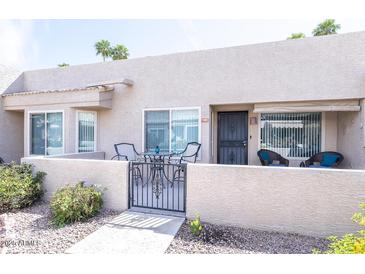 Charming gated front patio with seating area for outdoor relaxation and curb appeal at 14300 W Bell Rd # 222, Surprise, AZ 85374