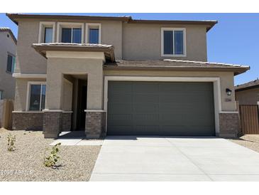 Charming two-story home featuring a two-car garage, neutral color palette, and well-maintained landscaping at 22382 W Monona Ln, Surprise, AZ 85387
