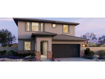Stunning two-story home featuring a modern design, attached two-car garage, and beautifully landscaped front yard at 22382 W Monona Ln, Surprise, AZ 85387