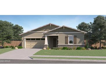 Charming single-story home with a two-car garage, well-maintained lawn, and beautiful desert landscaping at 25338 N 150Th Ln, Surprise, AZ 85387