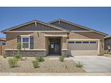 Charming single-story home featuring a two-car garage, neutral stucco, and desert landscaping for easy maintenance at 25338 N 150Th Ln, Surprise, AZ 85387
