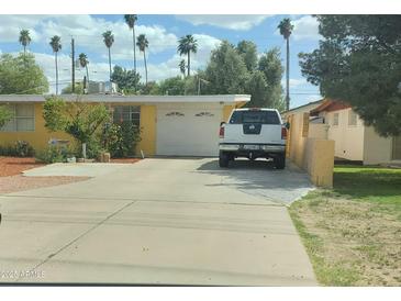 Charming single-story home featuring a spacious driveway and well-maintained landscaping at 3041 E Osborn Rd, Phoenix, AZ 85016