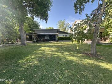 Charming single-story home featuring a lush green lawn and mature trees at 313 E 15Th St, Tempe, AZ 85281