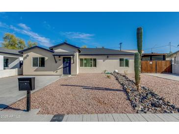 Charming single-story home with a xeriscaped front yard and a classic desert-inspired landscape at 542 E Flynn Ln, Phoenix, AZ 85012