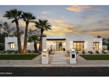 Stunning exterior showcasing a modern home design, palm trees, and manicured desert landscaping at 7001 E Joan De Arc Ave, Scottsdale, AZ 85254