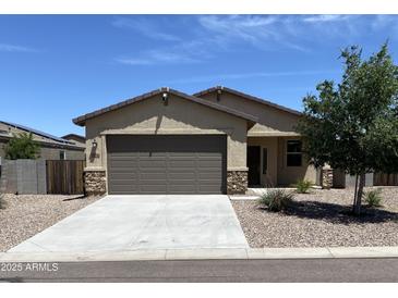 Charming single-story home featuring a two-car garage, well-maintained landscaping, and stone accents at 7218 E Grouse Ct, San Tan Valley, AZ 85143