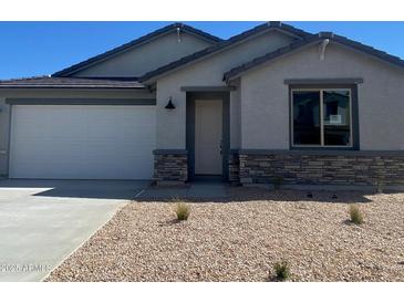 Charming single-story home features desert landscaping, stone accents, and a two-car garage at 7243 E Blissful Breeze Ln, San Tan Valley, AZ 85143