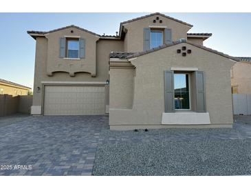Charming two-story home featuring a large driveway, two-car garage, and neutral color palette at 10984 N 164Th Dr, Surprise, AZ 85388