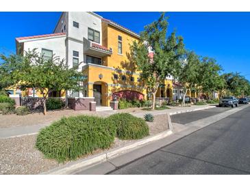 Inviting two-story exterior with vibrant colors, landscaped front, and a charming walkway entrance at 123 N Washington St # 16, Chandler, AZ 85225