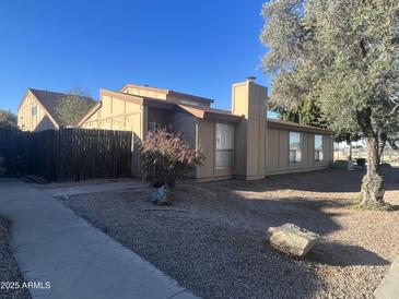 Charming home featuring a desert-landscaped front yard and a neutral-toned exterior in a pleasant residential neighborhood at 12445 N 21St Ave # 4, Phoenix, AZ 85029