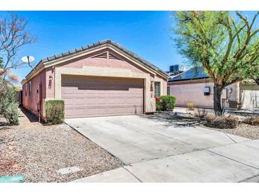 Charming single story home featuring a two-car garage, low maintenance landscaping, and a neutral color palette at 12938 W Mandalay Ln, El Mirage, AZ 85335