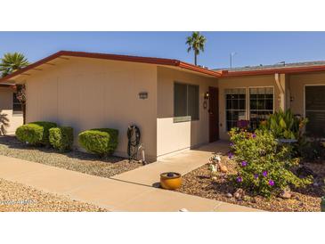 Cozy single-story home with desert landscaping, covered entry, and red trim at 13211 W Aleppo Dr, Sun City West, AZ 85375
