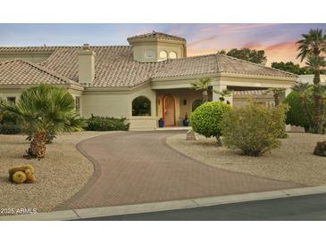 Charming home featuring lush landscaping, a curved driveway, and desert-friendly greenery at 14123 W Greentree S Dr, Litchfield Park, AZ 85340