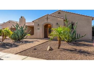 Inviting home with desert landscaping featuring a variety of cactus and stone walkway at 20139 E Via Del Oro --, Queen Creek, AZ 85142