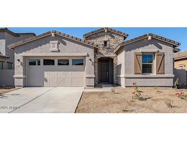 Charming single-story home with stucco siding, stone accents, and a two-car garage at 242 S 165Th Ave, Goodyear, AZ 85338
