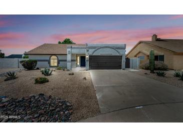 Charming single-story home boasting desert landscaping and a two car garage at 4902 E Golden St, Mesa, AZ 85205