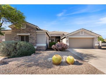 Charming single-story home with a stone facade, desert landscaping, and a two-car garage at 5090 E Sleepy Ranch Rd, Cave Creek, AZ 85331
