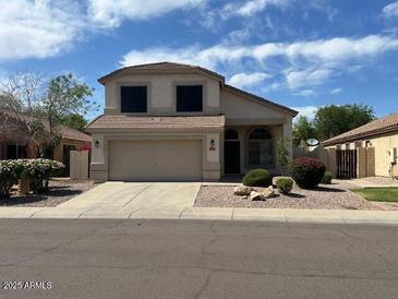 Charming two-story home features a well-maintained front yard and a two-car garage at 7176 W Blackhawk Dr, Glendale, AZ 85308