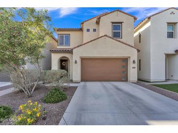 Charming two-story home featuring a brown garage door and manicured landscaping in a well-maintained neighborhood at 7234 W Aire Libre Ave, Peoria, AZ 85382