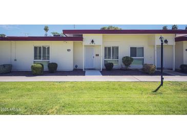 Charming home featuring well-maintained landscaping and a neatly manicured lawn at 10020 W Royal Oak Rd # F, Sun City, AZ 85351