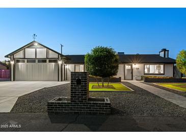 Charming single-story home featuring manicured front yard and modern architectural design at 11530 E Vine Ave, Mesa, AZ 85208