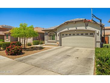 Charming single-story home with a two-car garage and basketball hoop at 12416 W Midway Ave, Glendale, AZ 85307