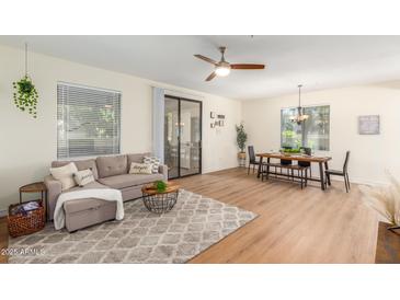 Spacious living room with a couch, a dining area, and a sliding glass door for ample natural light at 15252 N 100Th St # 1156, Scottsdale, AZ 85260