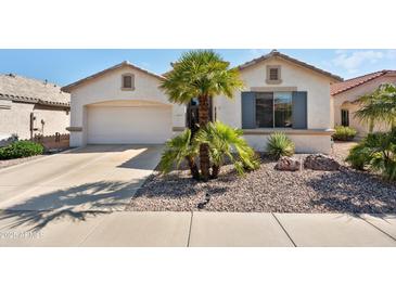 Charming single-story home showcasing a two-car garage and low-maintenance desert landscaping at 17611 W Ingleside Dr, Surprise, AZ 85374