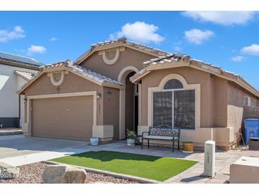 Charming single-story home with a well-manicured front yard and a cozy bench, showcasing curb appeal at 18845 N 23Rd Pl, Phoenix, AZ 85024
