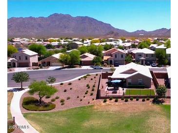 A lovely community view with mountain backdrop and well-maintained lawns on a bright, sunny day at 2070 E Saddlebrook Ct, Gilbert, AZ 85298