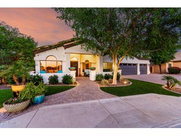 Charming facade with lush landscaping, brick walkway, and inviting front patio seating area at 2139 S Granite St, Gilbert, AZ 85295