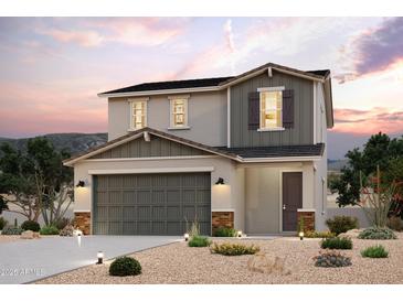 Two-story home showcasing a gray color scheme, complemented by desert landscaping at 2569 E Music Mountain Ave, Apache Junction, AZ 85119